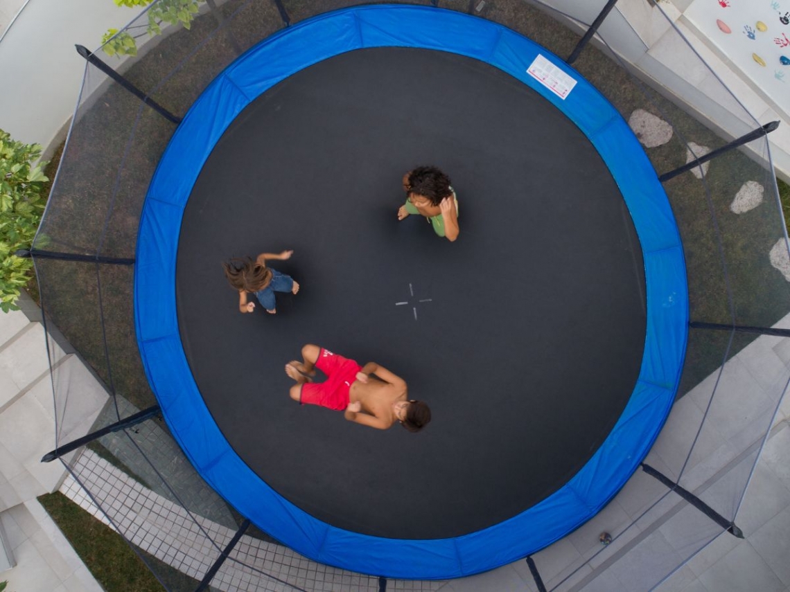 Three children playing on trampoline.jpg